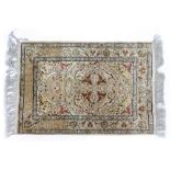 A TURKISH HEREKE SILK PRAYER RUG the central mihrab in a field of scrolling pastel coloured designs,