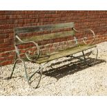 A GREEN PAINTED WROUGHT IRON GARDEN BENCH with scrolling ends and slatted back and seat, 161cm