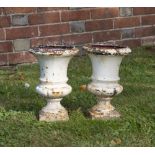 A PAIR OF MINIATURE CAST IRON WHITE PAINTED URNS of campana form, 16.5cm diameter x 25cm high (2)