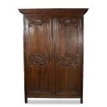 AN 18TH CENTURY FRENCH PROVINCIAL OAK ARMOIRE with carve fielded panelled doors and iron hinges with