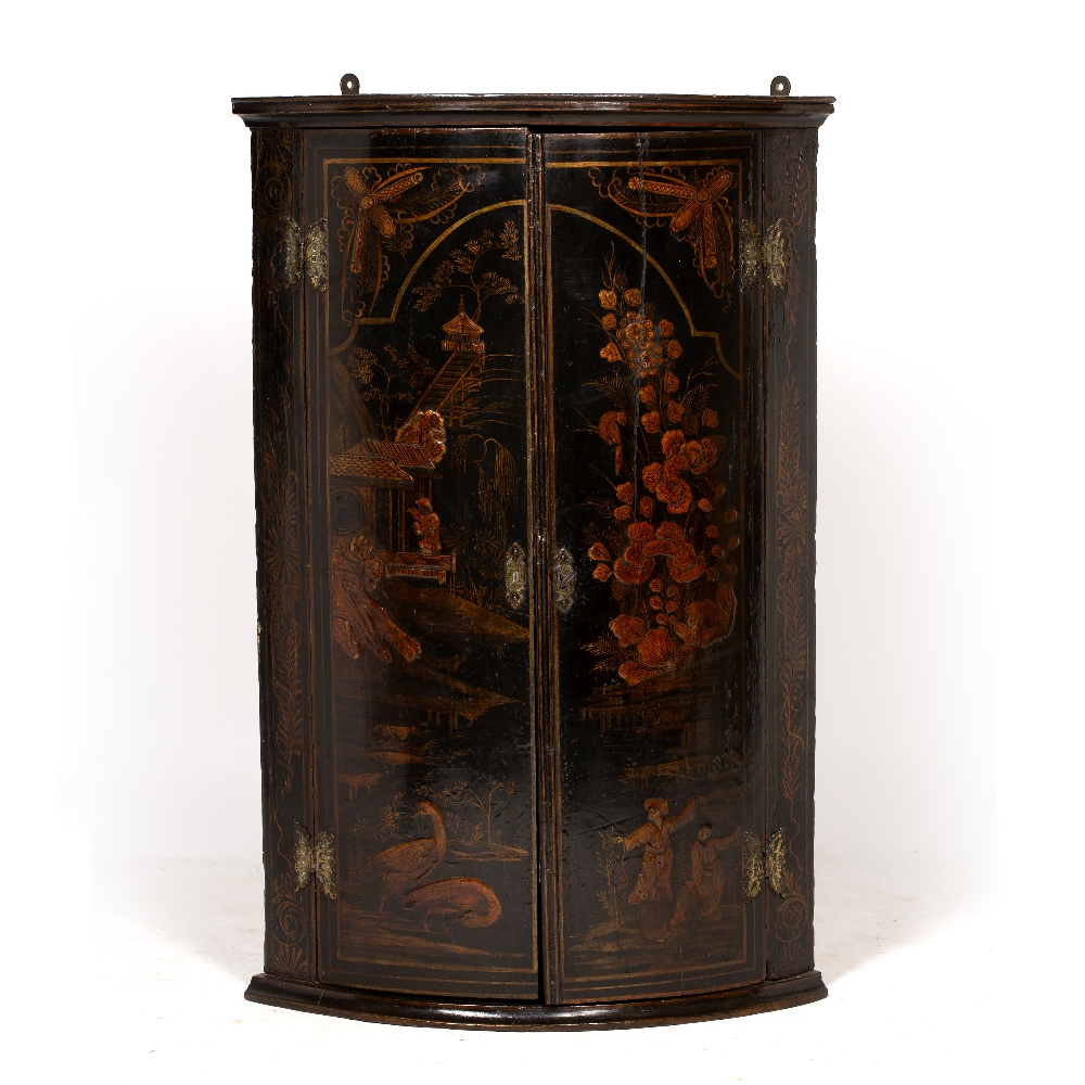A GEORGE III BLACK LACQUERED CHINOISERIE DECORATED TWO DOOR HANGING BOW FRONTED CORNER CUPBOARD,