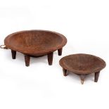 TWO SOUTH SEA ISLAND HARDWOOD CIRCULAR FEASTING BOWLS on short turned legs, the largest bowl 59cm