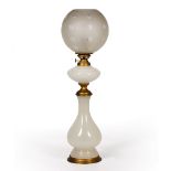 AN ANTIQUE WHITE GLASS TABLE LAMP with etched cut glass shade decorated with stars, 64.5cm high