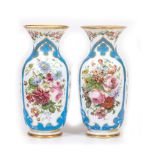 A PAIR OF FRENCH WHITE GLASS FLOWER DECORATED PARCEL GILT VASES with flaring rims, 17cm diameter x