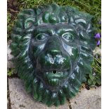 A GREEN GLAZED POTTERY WALL HANGING FOUNTAIN MASK in the form of a lion's head, 46cm wide x 55cm