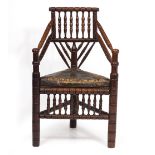 A 19TH CENTURY OAK TURNERS CHAIR with leather upholstered triangular seat and ring turned decoration