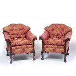 A PAIR OF EDWARDIAN MAHOGANY FRAMED ARMCHAIRS with caned shaped backs, scrolling arms and carved