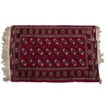 A BELOUCHE RED GROUND RUG with three rows of guls within a multiple banded border, 200 x 120cm