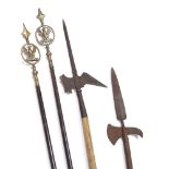 TWO OLD DECORATIVE IRON HALBERDS one on a pole, the other on a canvas covered pole together with a