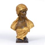 A LATE 19TH CENTURY CONTINENTAL POTTERY BUST by Goldscheider, the girl wearing a gilt head dress,