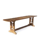 AN OLD PINE LONG SIDE TABLE with triple plank top, pierced decoration to the rectangular end