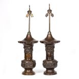 A PAIR OF BRONZE TABLE LAMPS in the Oriental style decorated with dragons and fruiting branches, the