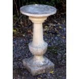 A RECONSTITUTED CAST STONE GARDEN SUN DIAL the circular top with baluster support and on a square
