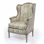 AN ANTIQUE PAINTED BEECH FRAMED WING BACK OPEN ARMCHAIR with acanthus scrolling arms, fluted