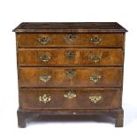 AN EARLY GEORGE III WALNUT SMALL SIZED CHEST of four long graduated drawers and a crossbanded top