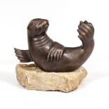 A BRONZE FOUNTAIN IN THE FORM OF A SEAL mounted on a section of limestone, the seal 44cm wide x 27cm