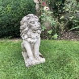 A CAST RECONSTITUTED STONE SCULPTURE in the form of a seated lion, 57cm high