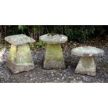 A GROUP OF THREE VARIOUS STADDLE STONES each with cast concrete bases and old stone tops of