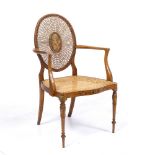 AN EDWARDIAN HEPPLEWHITE STYLE PAINTED SATINWOOD SIDE CHAIR with caned oval back and serpentine