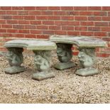 A PAIR OF CAST RECONSTITUTED STONE CURVED GARDEN SEATS with squirrel supports, 110cm wide x 44cm