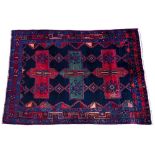 A HAMADAN DARK BLUE GROUND RUG with three cross designs to the central field within a triple