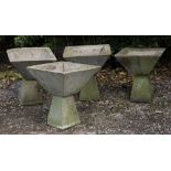A SET OF FOUR CAST CONCRETE SQUARE SECTION PLANTERS of conical form on spreading bases, each 48cm