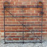 AN OLD BLACK PAINTED WROUGHT IRON GATE, approximately 110cm wide x 117cm high