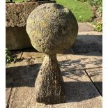 A Ball FINIAL of carved stone, 17cm diameter on a tapering stand, 43cm high overall