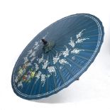 A JAPANESE BLUE GROUND PARASOL painted with white blossom on a branch, approximately 150cm diameter