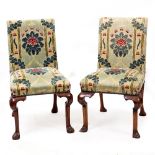 A SET OF SIX GEORGE II STYLE SIDE CHAIRS with overstuffed upholstered backs and seats and carved