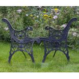 A PAIR OF BLACK PAINTED CAST IRON BENCH ENDS approximately 50cm wide x 74cm high