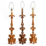 AN ANTIQUE CARVED PINE ALTAR CANDLESTICK with carved acanthus leaf and ornament and tripod base,