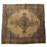 A CAMEL GROUND TURKEY RUG with diamond designs to the central field with bracketed corners and