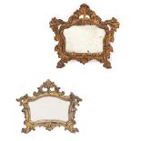 AN ANTIQUE ITALIAN MIRROR with silvered gesso moulded scrolling frame around the shaped mirror
