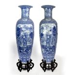 A PAIR OF VERY LARGE CHINESE BLUE AND WHITE FLOOR VASES decorated with figures fighting in