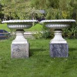 A PAIR OF VICTORIAN STYLE WHITE PAINTED CAST ALUMINIUM SHALLOW URNS of campana form with egg and