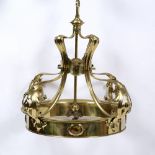 AN ART NOUVEAU BRASS HANGING LIGHT FITTING with scrolling pierced supports and circular ring set