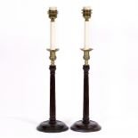 A PAIR OF GEORGIAN STYLE MAHOGANY TABLE LAMPS with fluted stems and circular spreading bases, 14cm