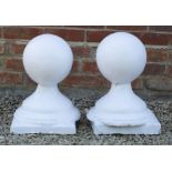 A PAIR OF WHITE PAINTED CAST RECONSTITUTED STONE BALL FINIALS ON STANDS each finial approximately
