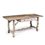 A SPANISH STYLE PINE SIDE TABLE with single frieze drawer, shaped end supports with associated
