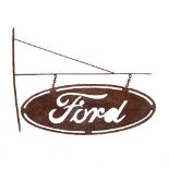 A RUSTED STEEL HANGING OVAL PIERCED FORD SIGN, with bracket, 124cm wide x 88cm high