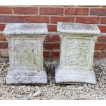A PAIR OF CAST RECONSTITUTED STONE SQUARE TOPPED PLINTHS the sides decorated with panels of fruiting