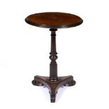 A ROSEWOOD WINE TABLE with circular top, turned and fluted column support, triform base and