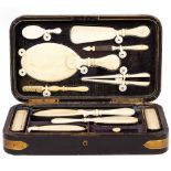 A CONTINENTAL DRESSING TABLE BOX with ivory implements to include two hand mirrors, toothbrush,