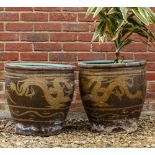 A PAIR OF ORIENTAL STONEWARE PLANTERS OR BOWLS decorated with dragons to the exterior and with