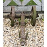 AN ANTIQUE CAST AND WROUGHT IRON WAGON WHEEL CLEANER with spoked wheels, 50cm wide x 110cm long