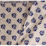 THREE ROLLS OF LAURA ASHLEY CREAM GROUND MATERIAL decorated with blue flowers together with a