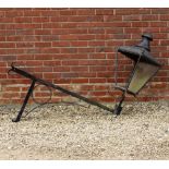 AN OLD COPPER LANTERN 43cm wide x 29cm high on a wrought iron corner bracket, measuring