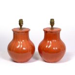 A PAIR OF PEACH COLOURED POTTERY TABLE LAMPS, 17cm diameter x 29cm high to the top of the fitting