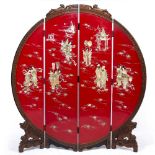 A JAPANESE STYLE RED LACQUERED MOON SCREEN four fold design with carved flower head and figural